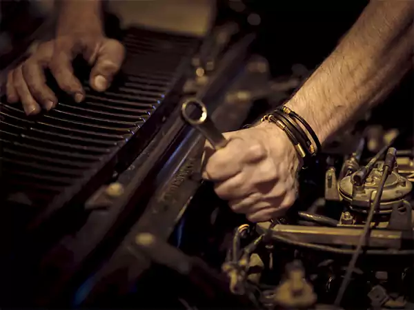 Loosening Car Battery Holder with a Wrench