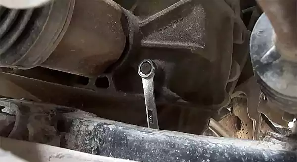 Loosening the inspection plug with a wrench