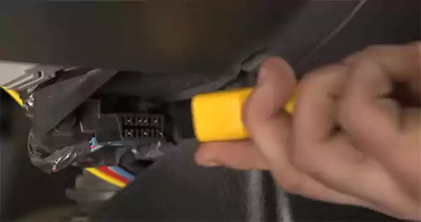 Plugging the OBD scanner into the port